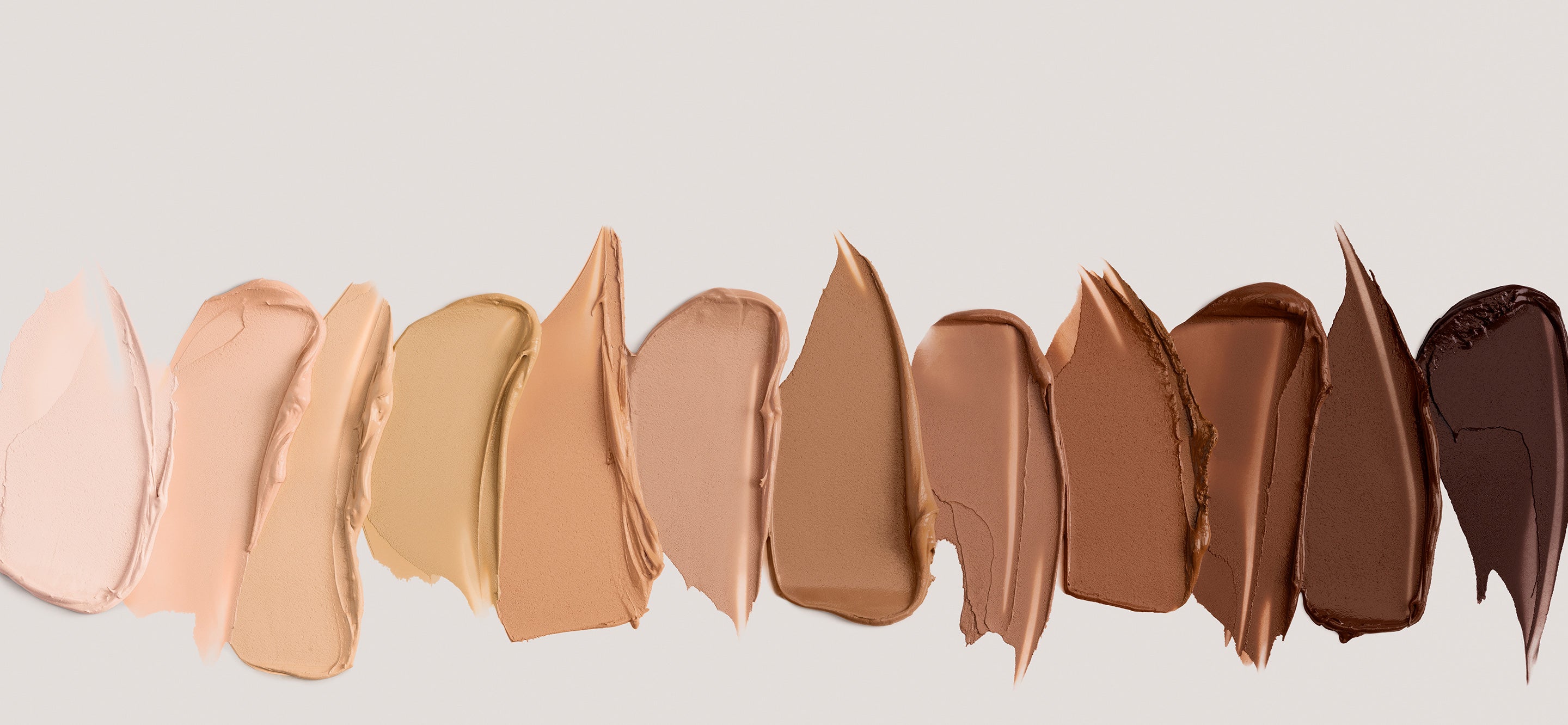Swatches of ILIA complexion products in a range of shades from light to deep.