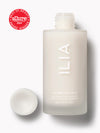 ILIA The Base Face Milk bottle with cap off, highlighting its minimalist design and award badge.
