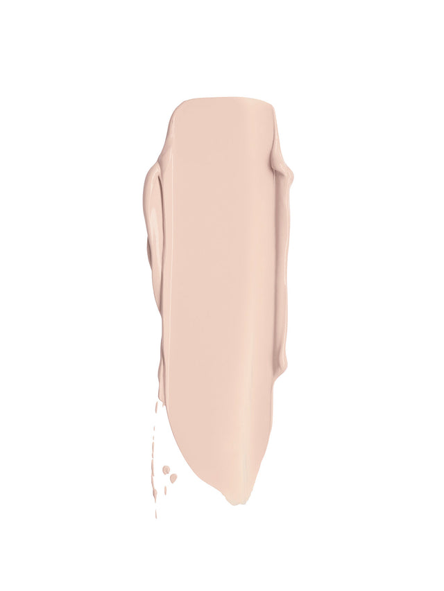 Smooth swipe of cool toned liquid concealer with creamy texture on a white background.