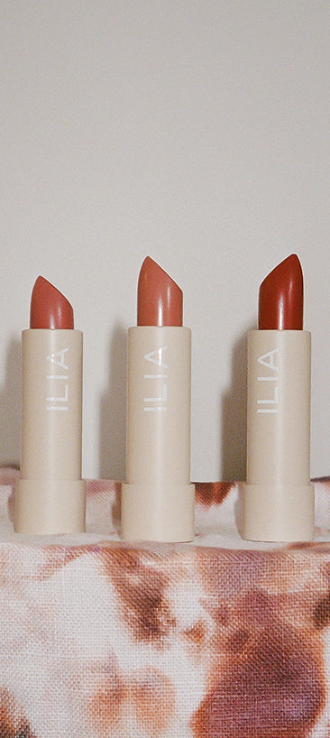 Three ILIA lipsticks with a neutral background to support gift with purchase over $75.