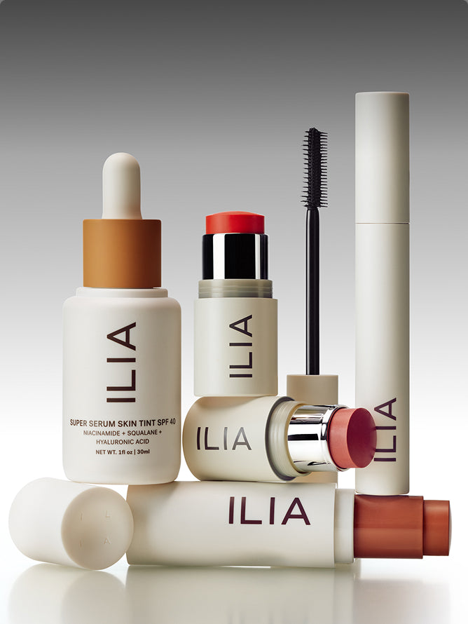 Set of ILIA skincare and makeup products on a gray background
