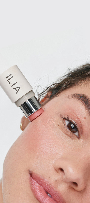 ILIA multi-stick lip and cheek product being applied to a face to support the free gift on orders $75+